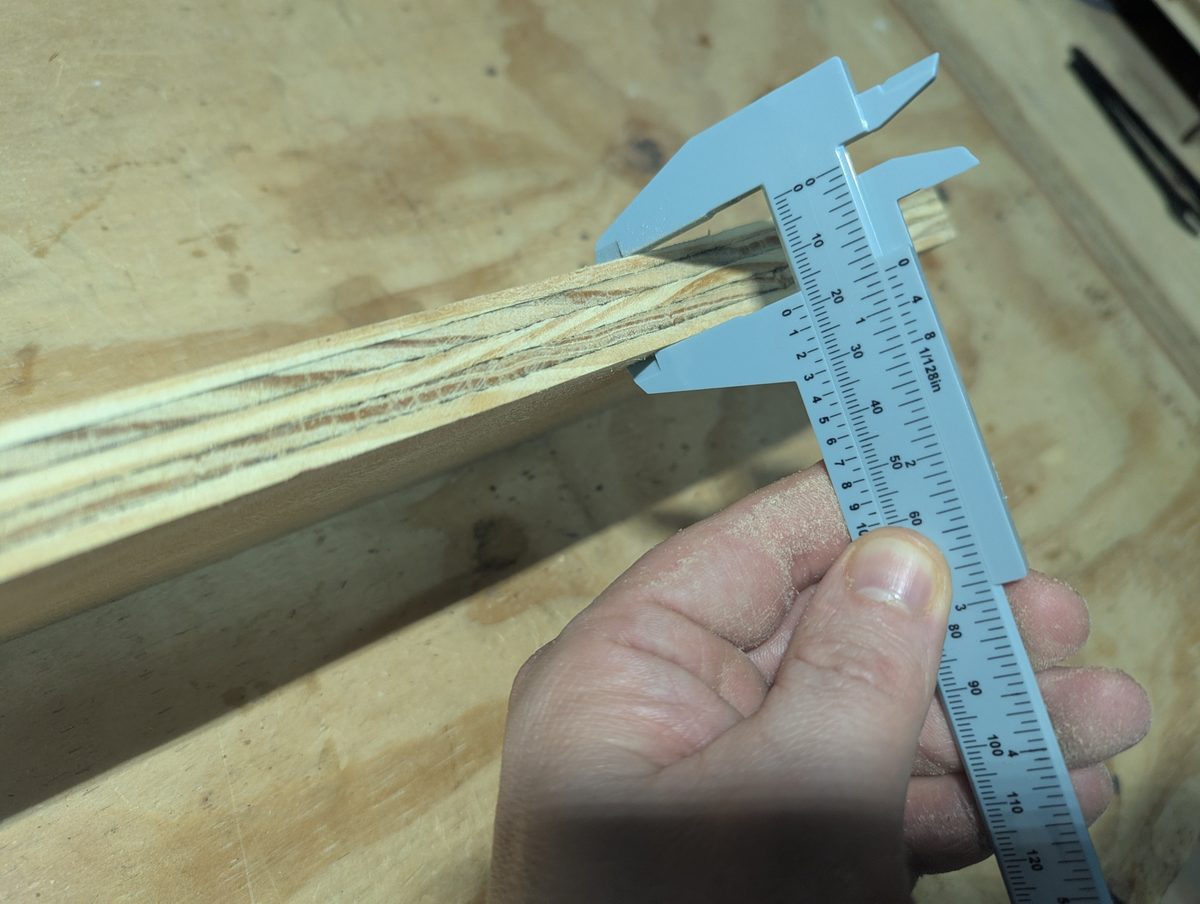 Digital calipers measuring actual plywood thickness