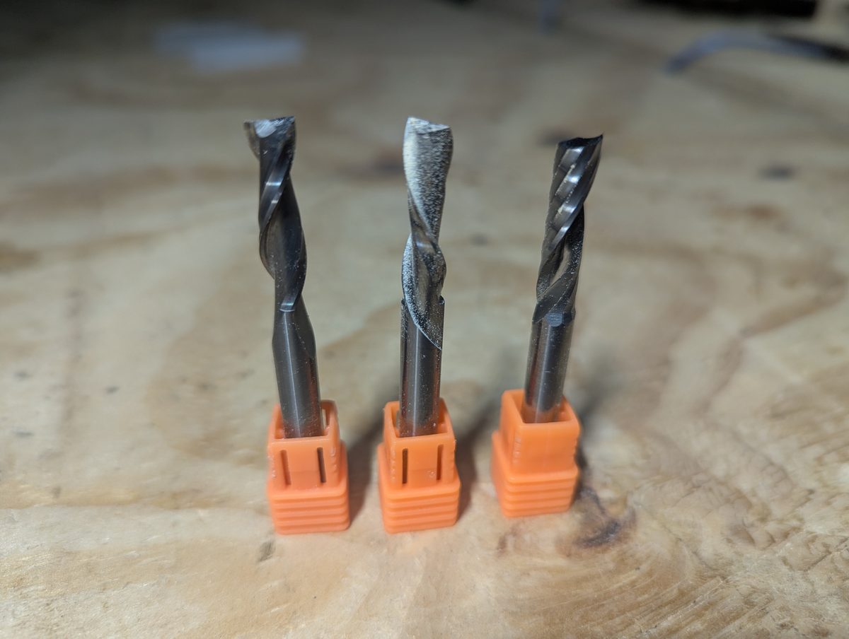 Upcut, downcut, and single flute CNC router bits side by side